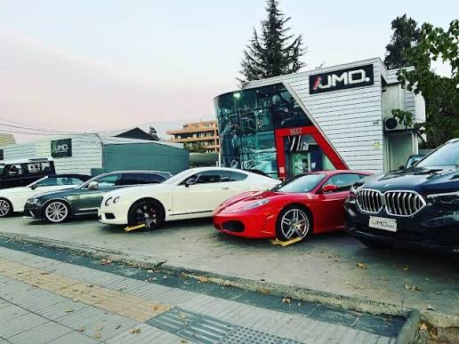 Patio de JMD con Bentley y Ferrari